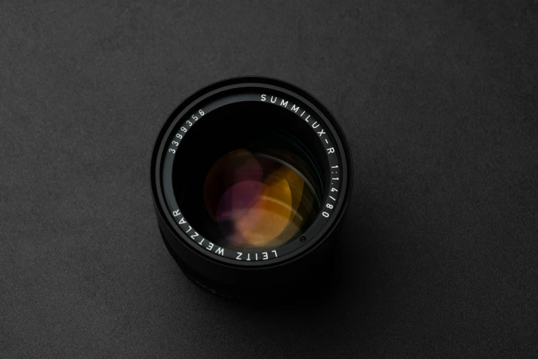 a camera lens on a black surface, a picture, by Eero Snellman, unsplash contest winner, photorealism, medium format. soft light, leica summilux 5 0 mm f / 1. 4, detailed product image, medium format