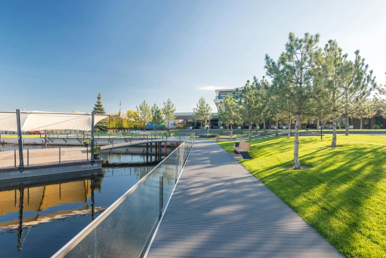 a wooden walkway next to a body of water, modernism, southdale center, grey, thumbnail, green spaces