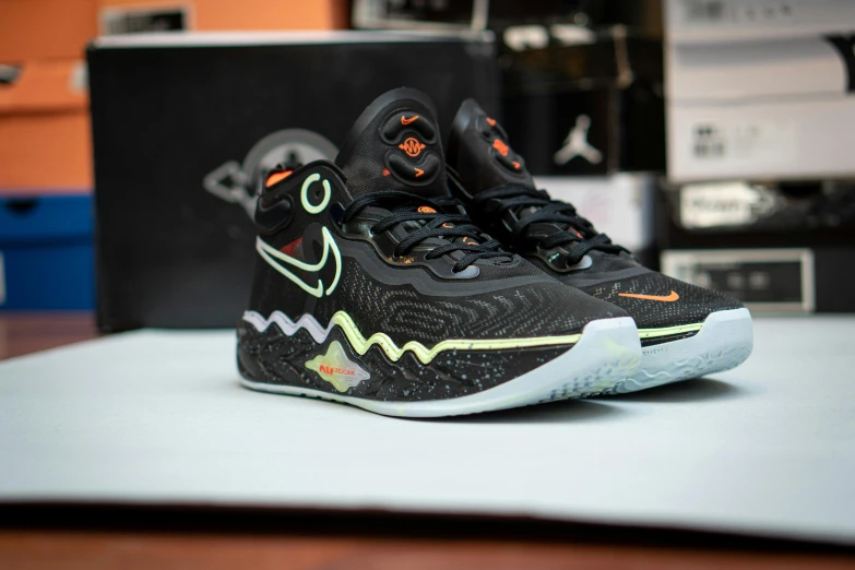 a pair of shoes sitting on top of a table, reddit, holography, black and orange, celtics, kitbash, zig zag