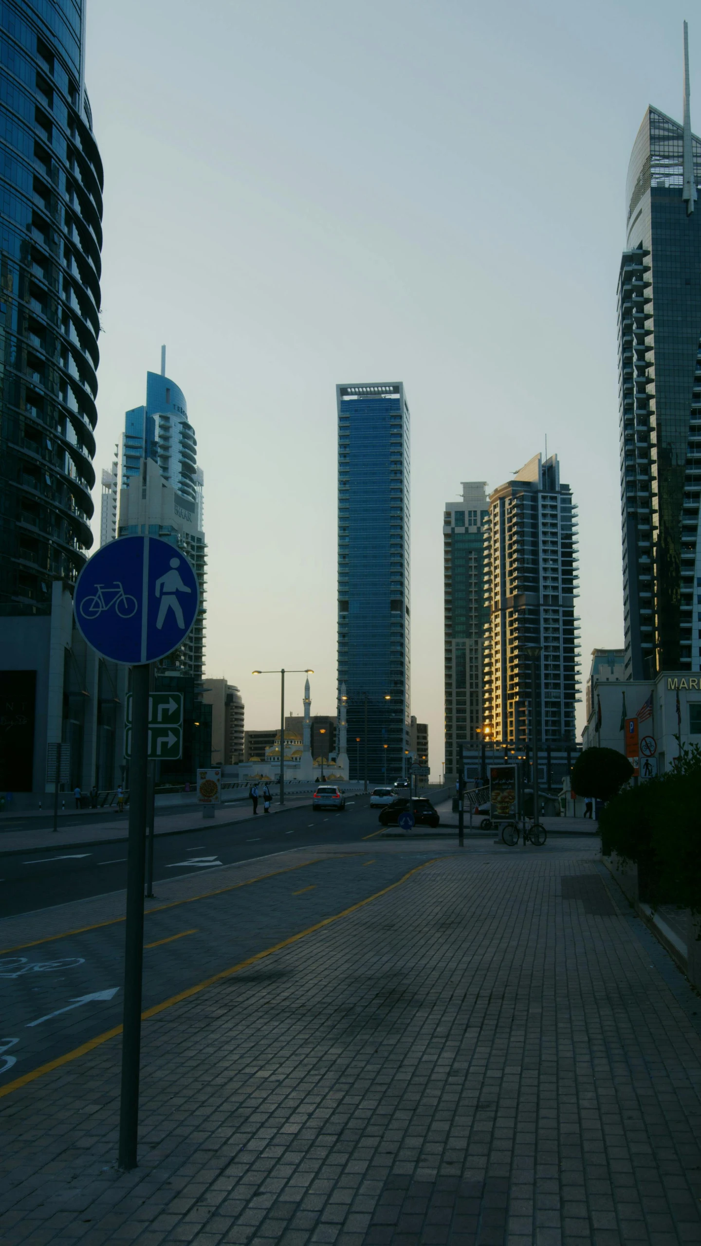 a city street filled with lots of tall buildings, hurufiyya, gta : dubai, low quality photo