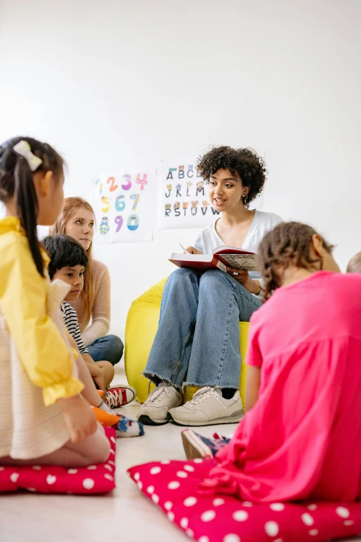 a woman reading a book to a group of children, pexels contest winner, art & language, inspect in inventory image, mix of ethnicities and genders, in australia, slide show