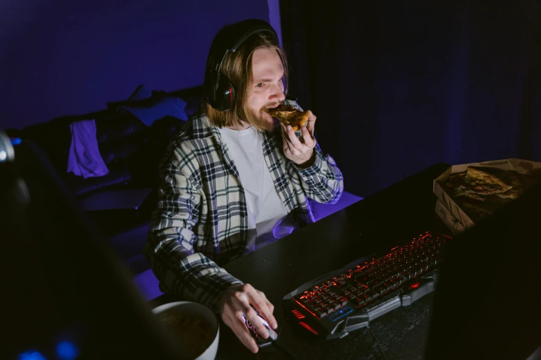a man sitting at a desk eating a doughnut, by Julia Pishtar, pexels contest winner, pc gaming, eating garlic bread, mid night, discord profile picture