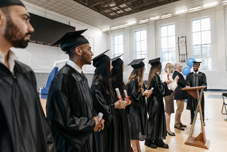 a group of people standing next to each other in graduation gowns, by Carey Morris, pexels contest winner, academic art, inspect in inventory image, background image, instagram post, standing in class