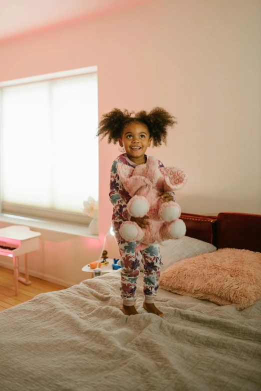 a little girl standing on a bed holding a teddy bear, she has two ponytails, cotton candy trees, early morning lighting, doja cat