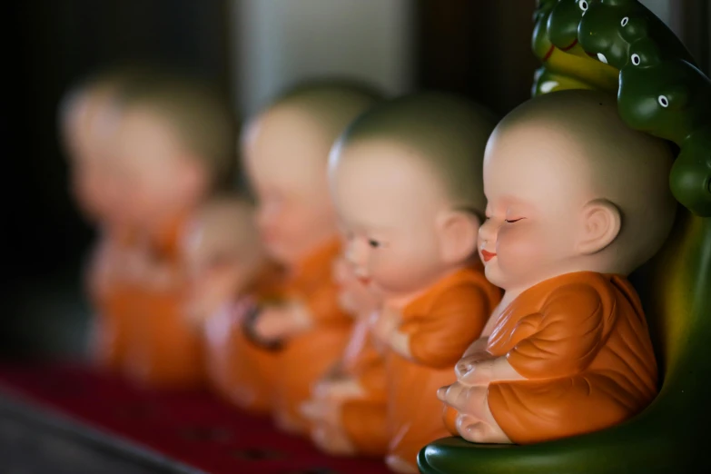 a row of buddha statues sitting next to each other, a statue, by Lee Loughridge, human babies, in style of lam manh, profile image, fisting monk