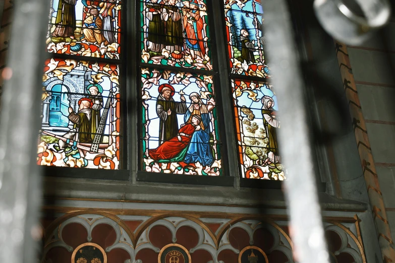 a stained glass window inside of a church, a picture, by Jan Tengnagel, pexels, renaissance, payne's grey and venetian red, behind the scenes, slide show, multicoloured