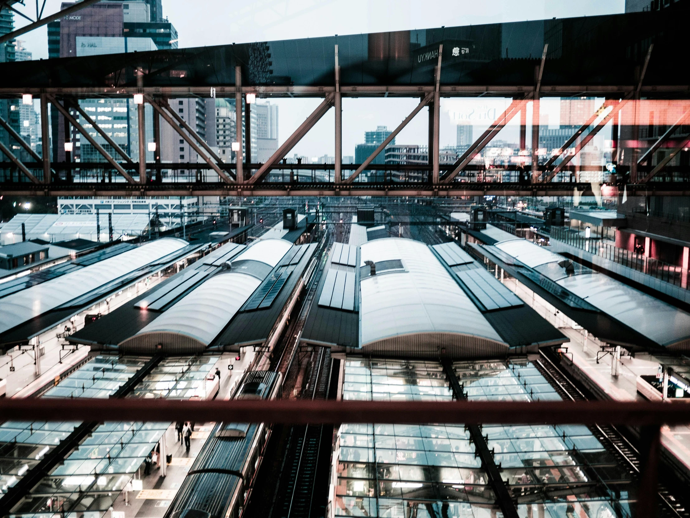 a train station with many trains on the tracks, inspired by Andreas Gursky, unsplash contest winner, japanese glass house, thumbnail, upside - down building, japanese downtown