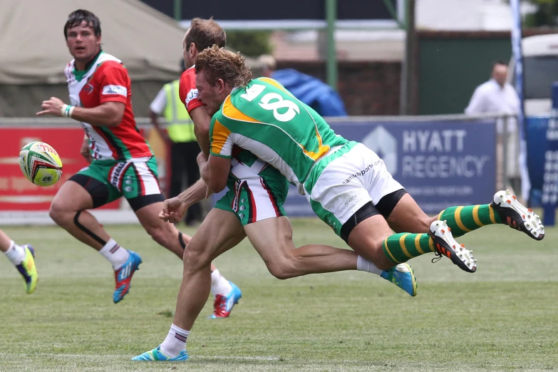 a group of men playing a game of rugby, green and gold, ruan jia and mandy jurgens, hip and leg shot, tournament