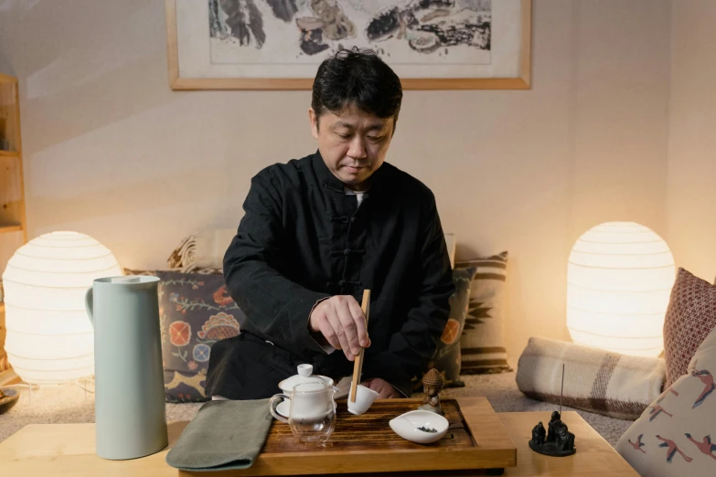 a man sitting at a table with a tray of food, inspired by Tani Bunchō, secret tea society, 千 葉 雄 大, exclusive, white