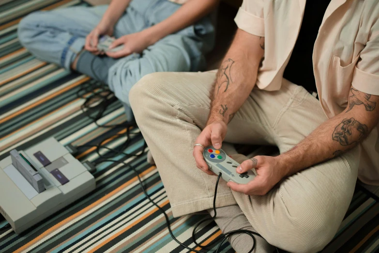 a man sitting on the floor playing a video game, trending on pexels, hyperrealism, twins playing video games, cottagecore hippie, super nintendo, 15081959 21121991 01012000 4k