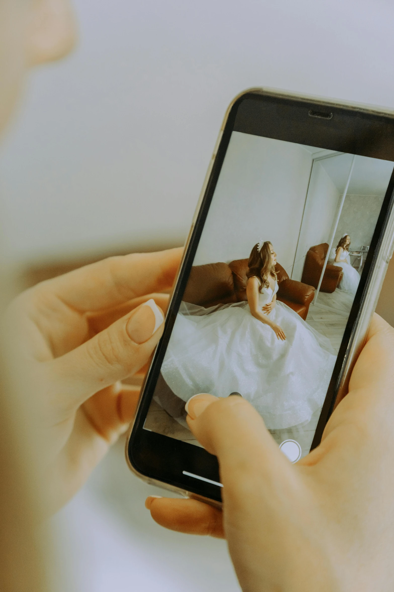 a woman taking a picture of herself on her cell phone, a picture, by Robbie Trevino, pexels contest winner, wearing a wedding dress, mobile still frame. 4k uhd, couple on bed, mobile learning app prototype