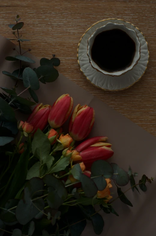 a bouquet of tulips and a cup of coffee on a table, a still life, pexels contest winner, romanticism, eucalyptus, black and terracotta, low detail, scene from a dinner party