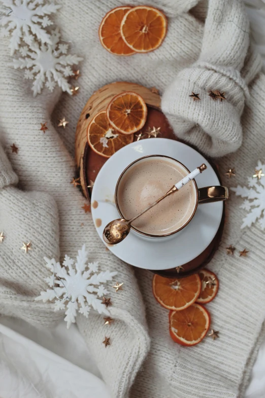 a cup of coffee sitting on top of a table, a still life, by Julia Pishtar, trending on pexels, snowflakes, ivory and copper, made of wool, thumbnail