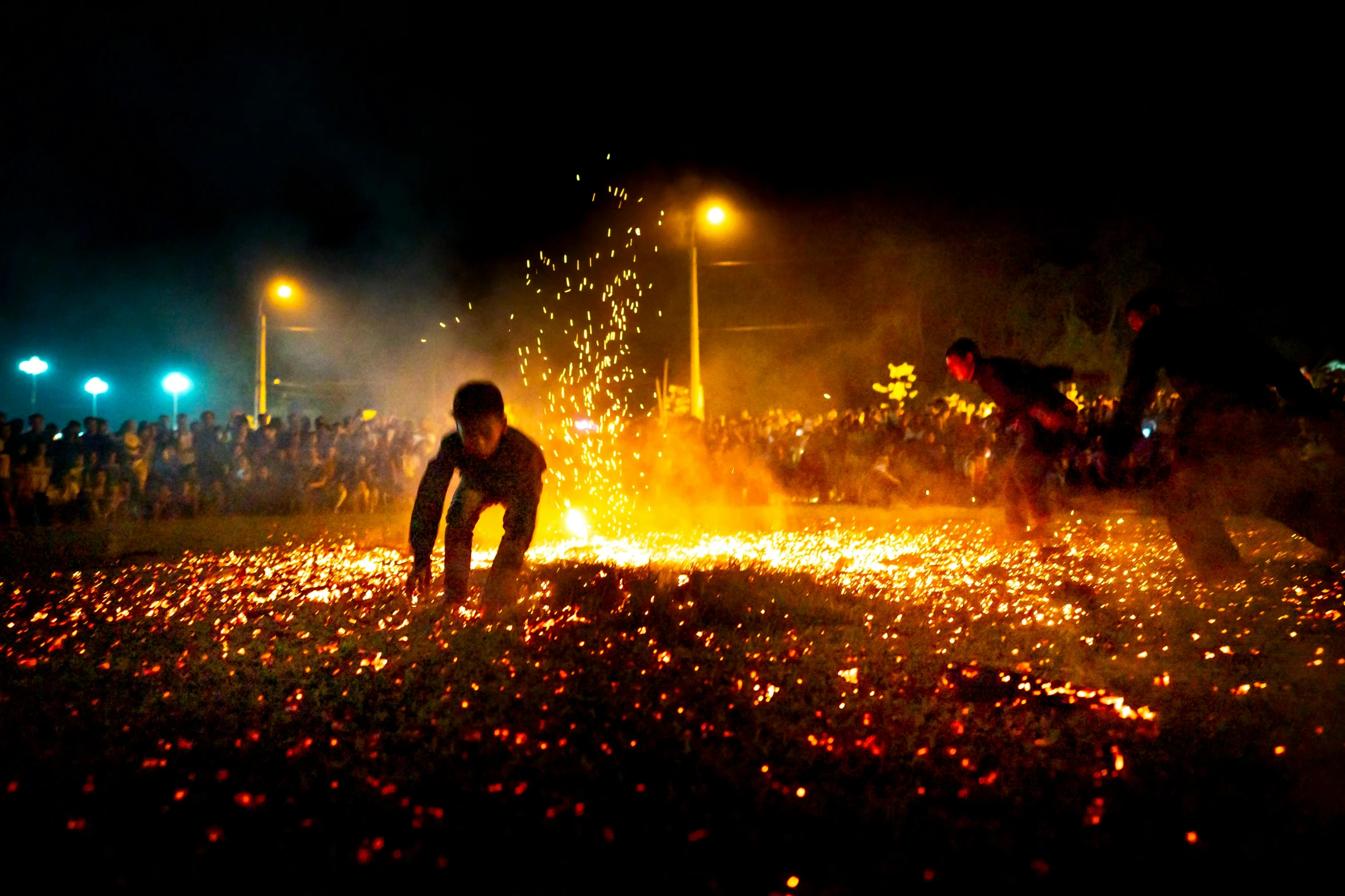 a person kneeling on the ground in front of a fire, happening, flowers exploding and spraying, summer festival night, avatar image, ignant