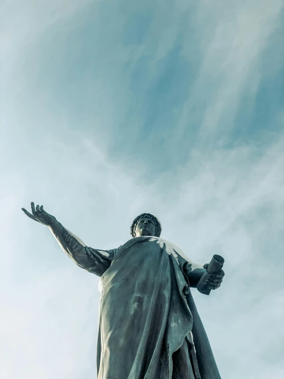a statue of jesus on top of a building, a statue, by Niko Henrichon, pexels contest winner, waving robe movement, lenin, 🚿🗝📝, view from ground level