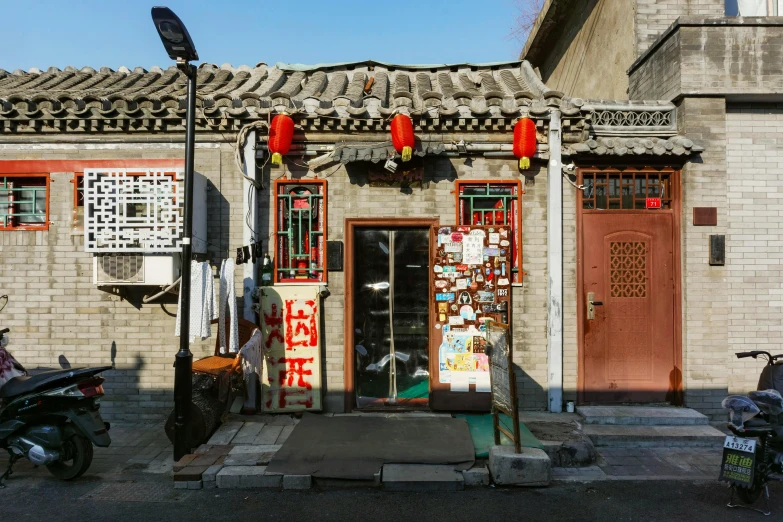 a couple of motorcycles parked in front of a building, a silk screen, pexels contest winner, cloisonnism, chinese lanterns, shop front, conde nast traveler photo, preserved historical