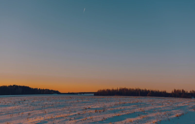 a man flying a kite on top of a snow covered field, by Attila Meszlenyi, twilight ; wide shot, large moon in the sky, cinematic shot ar 9:16 -n 6 -g, swedish countryside