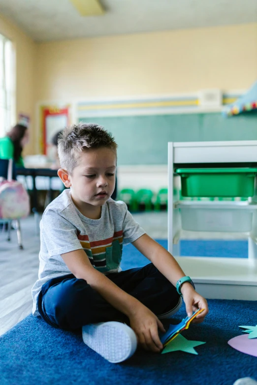 a young boy sitting on the floor reading a book, pexels contest winner, american barbizon school, tending on art station, in a classroom, thumbnail, keter class