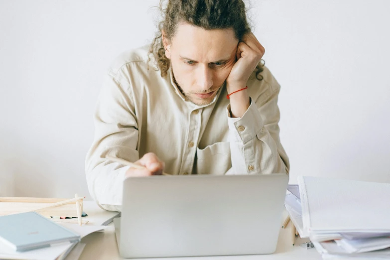 a man sitting in front of a laptop computer, pexels, hozier, concerned, avatar image, instagram post