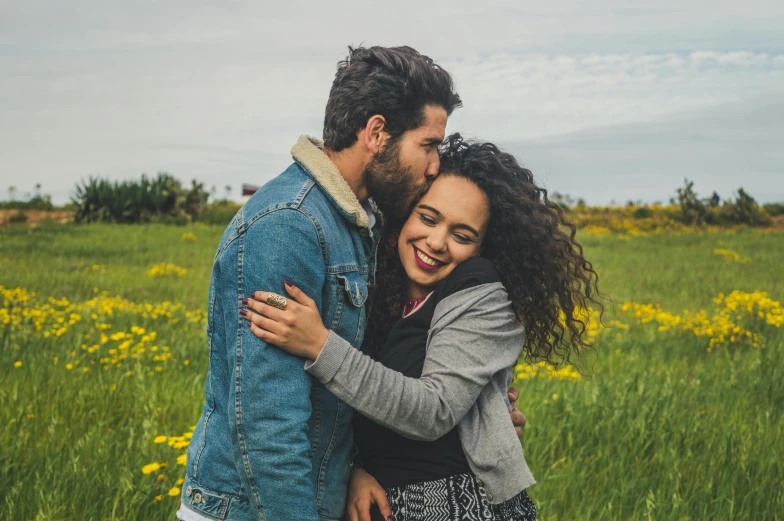 a man and woman embracing in a field of flowers, pexels contest winner, happening, nathalie emmanuel, happy girl, casually dressed, hispanic