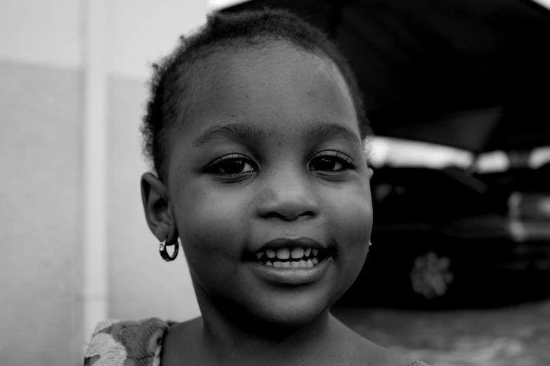 a black and white photo of a young girl, by Nadir Afonso, friendly smile, black young woman, 8k 50mm iso 10, medium format. soft light