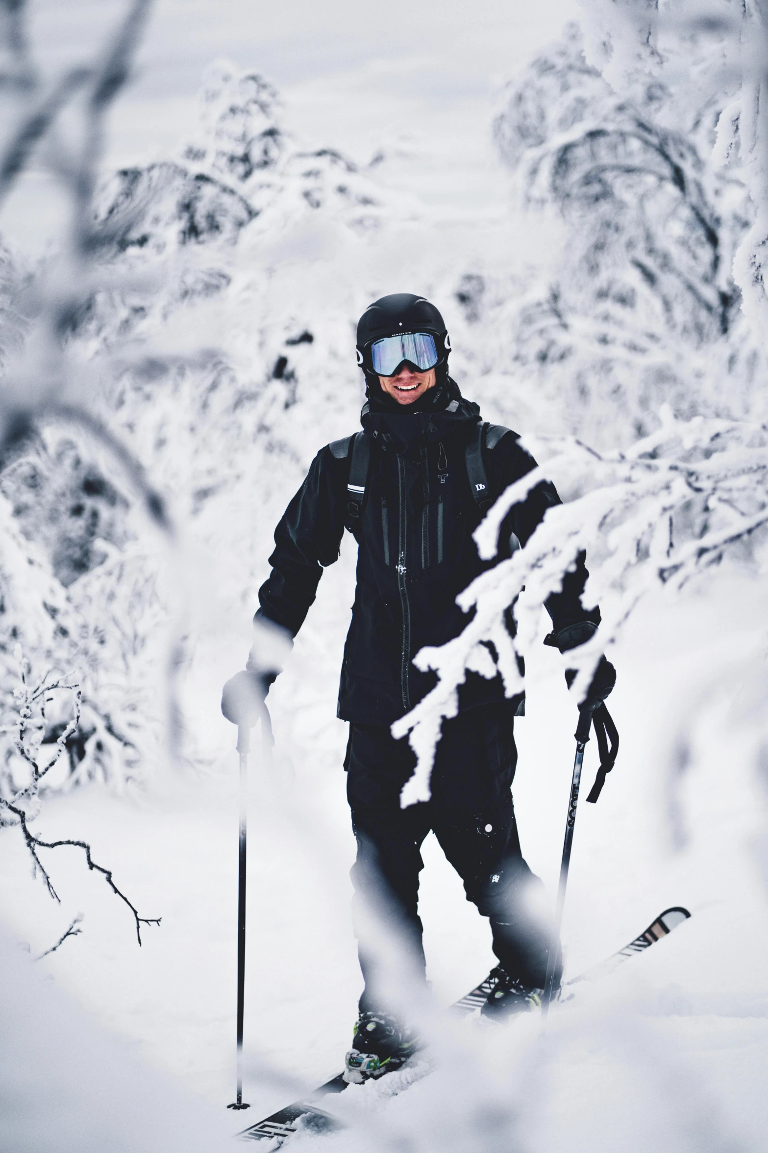 a man riding skis down a snow covered slope, by Veikko Törmänen, pexels contest winner, baroque, photograph of a techwear woman, amongst foliage, good looking, grey