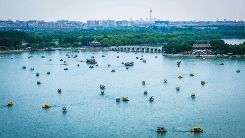 a large body of water filled with lots of boats, inspired by Wang Lü, pexels contest winner, baotou china, fujifilm”, cinematic”, parks and monuments