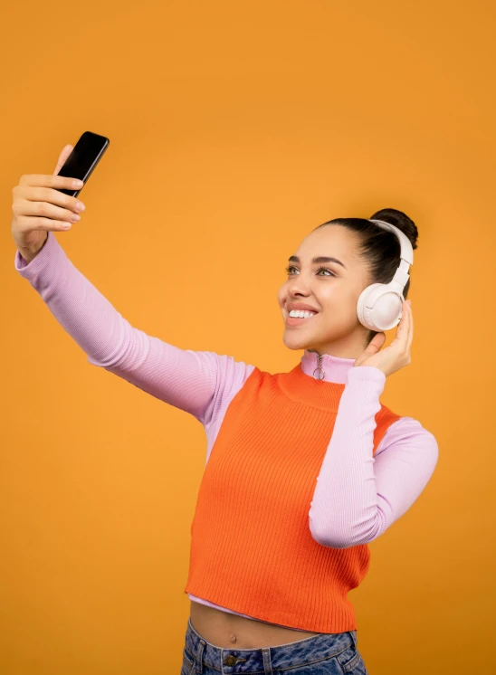 a woman taking a selfie with her cell phone, trending on pexels, orange metal ears, avatar image, full body image, square