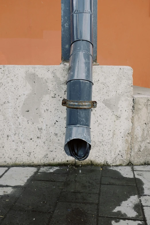 a blue fire hydrant sitting on top of a cement block, an album cover, by Attila Meszlenyi, renaissance, large pipes, grey, close - up photograph, running water