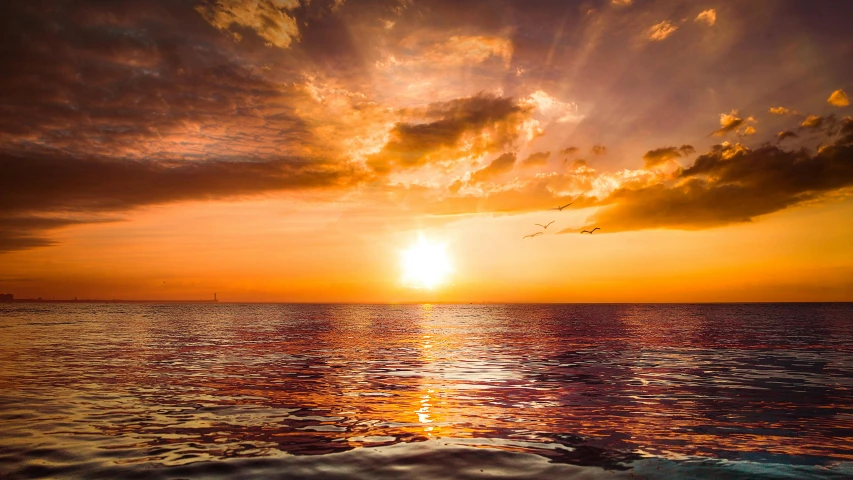 a large body of water under a cloudy sky, pexels contest winner, romanticism, orange sun set, a photo of the ocean, youtube thumbnail, exotic endless horizon