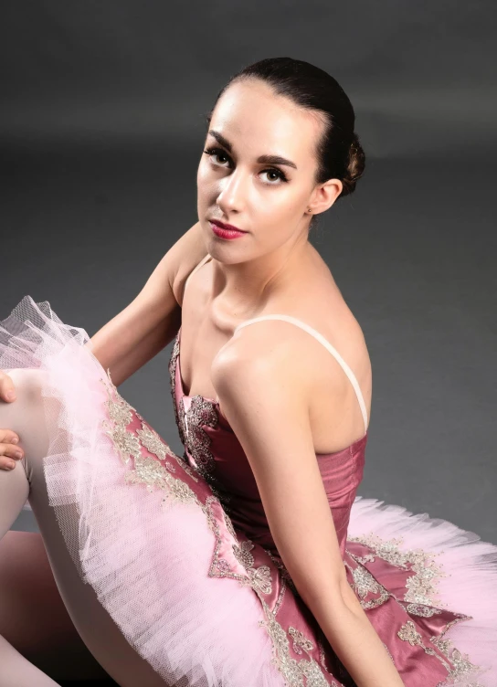 a woman in a pink dress is sitting on the floor, by Arabella Rankin, arabesque, headshot photo, wearing a tutu, promo image, square