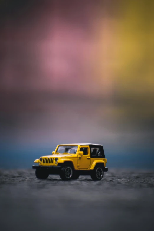 a toy jeep sitting on top of a sandy beach, a picture, by James Warhola, unsplash, minimalism, gradient yellow, jeep wrangler, rain lit, avatar image