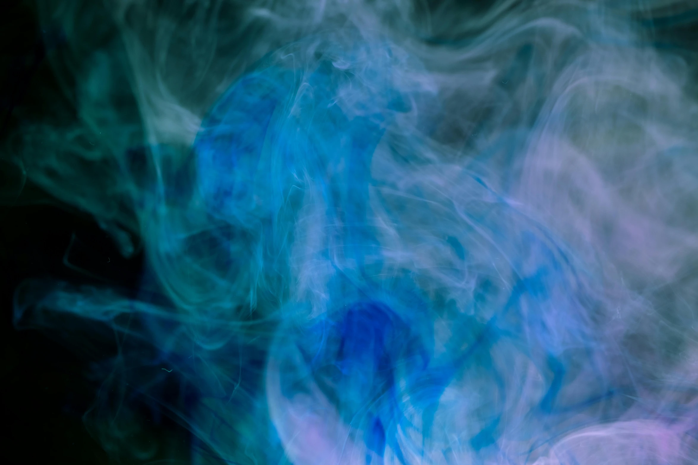 a close up of smoke on a black background, inspired by Kim Keever, pexels, gradient cyan to blue, photo of a ghostly pirate, mystical swirls, mauve and cyan