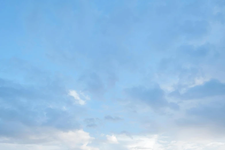 a man flying a kite on top of a lush green field, unsplash, minimalism, layered stratocumulus clouds, light-blue, today\'s featured photograph 4k, pale blue