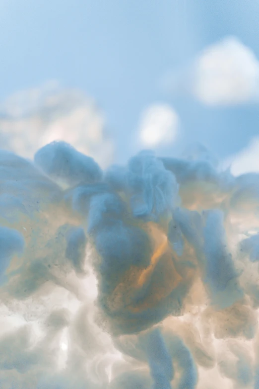 a plane flying through a cloudy blue sky, inspired by Kim Keever, lyrical abstraction, close up of single sugar crystal, sitting in a fluffy cloud, rendered in houdini, orange clouds