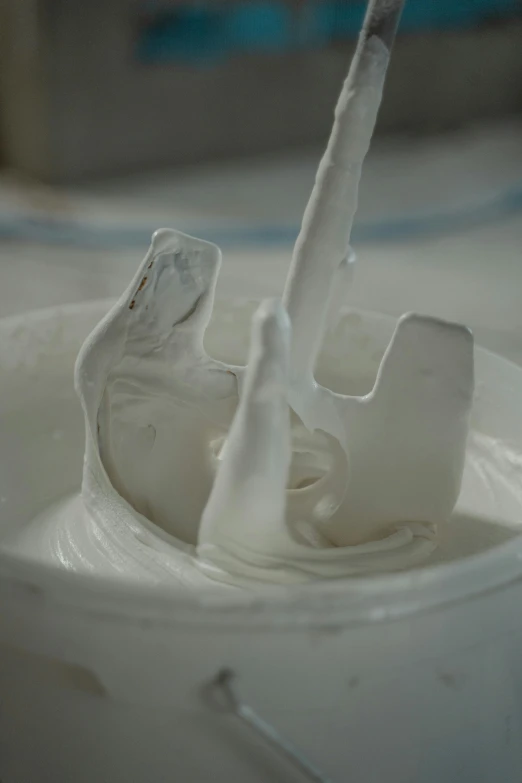 a cup of milk with a toothbrush sticking out of it, a marble sculpture, inspired by Lucio Fontana, reddit, process art, yogurt, detail shot, made of clay, whirlpool