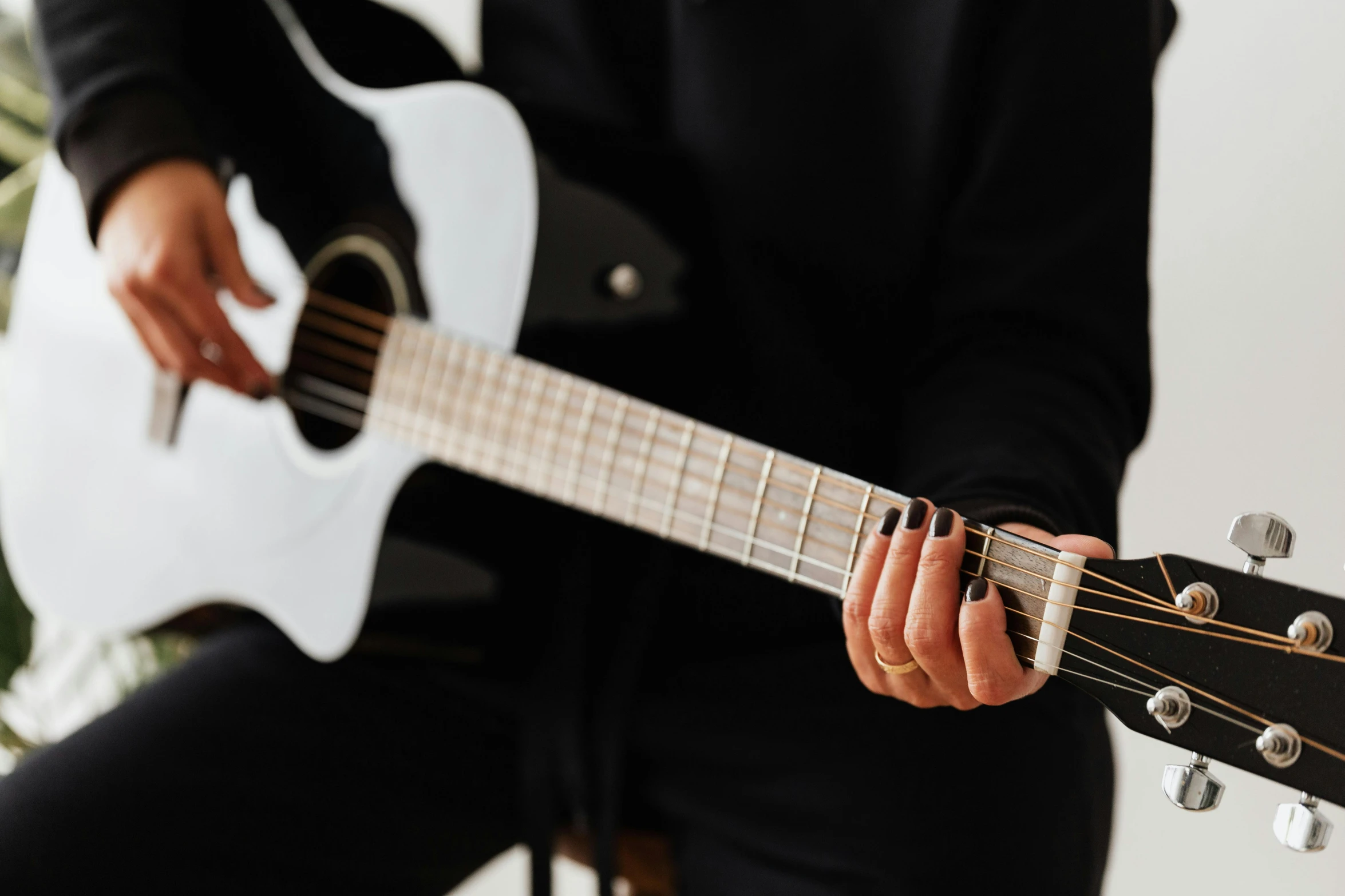 a close up of a person holding a guitar, white and black, black velvet, thumbnail, on a white table