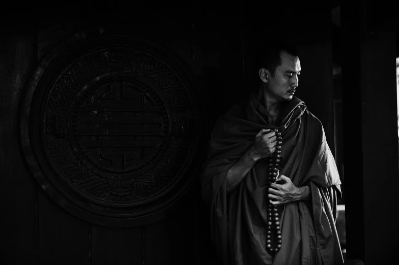 a black and white photo of a monk holding a sword, a portrait, inspired by Ma Quan, unsplash contest winner, musicians, cgsociety 4k”, waiting, wearing brown robes