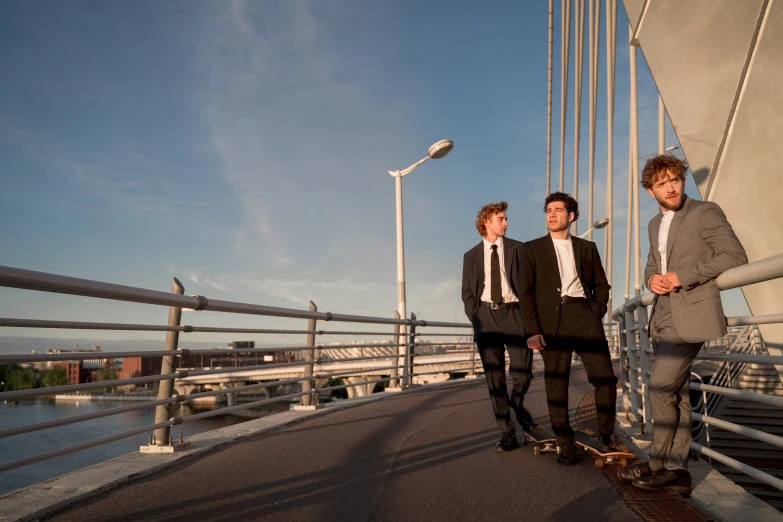 a couple of men standing next to each other on a bridge, happening, reservoir dogs, reykjavik junior college, suits, uplit