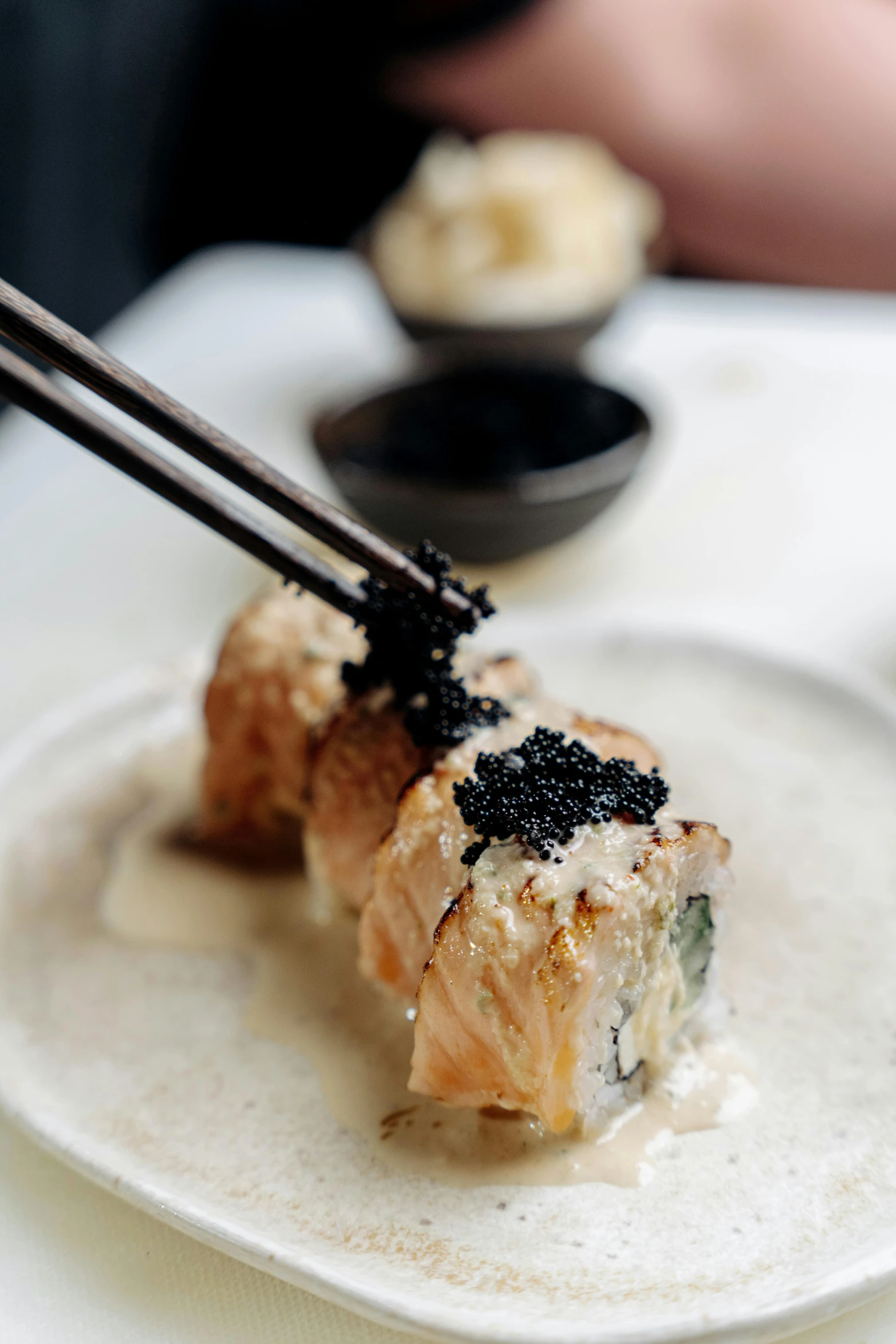 a close up of a plate of food with chopsticks, inspired by Maki Haku, unsplash, charcoal and champagne, a blond, hyperrealistic”