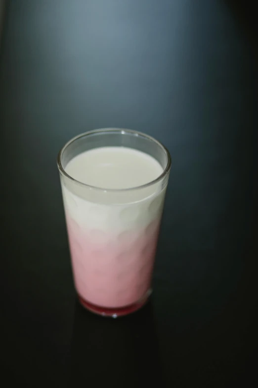 a glass of milk sitting on top of a table, gradient pink, promo image, rice, gradient white to red