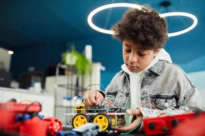 a young boy playing with legos at a table, trending on pexels, futuristic cars and mecha robots, with sparking circuits, avatar image, teenage engineering moad