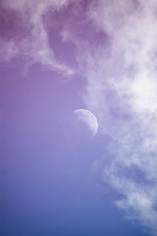 a plane flying in the sky with the moon in the background, unsplash, aestheticism, pastel purple background, cloud iridescence, colour photograph, street moon landscape