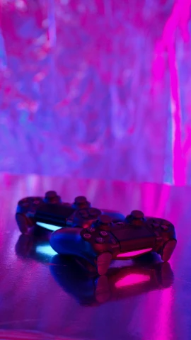 a video game controller sitting on top of a table, by Gwen Barnard, pexels, conceptual art, bright pink purple lights, playstation 4, twins playing video games, colored gel lighting