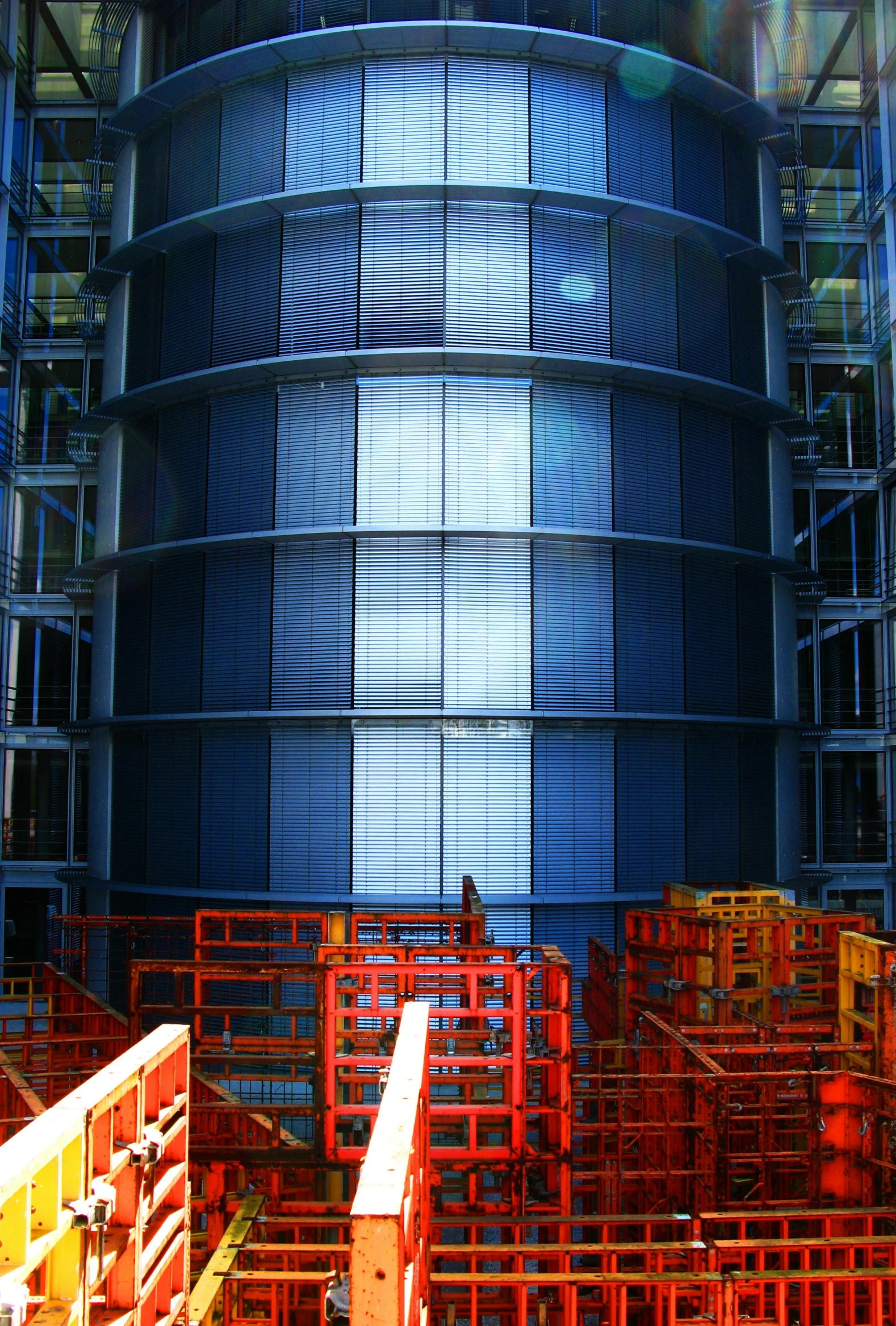 a very tall building with a lot of windows, by Doug Ohlson, large hadron collider, metal panels, deep colours. ”, barrels