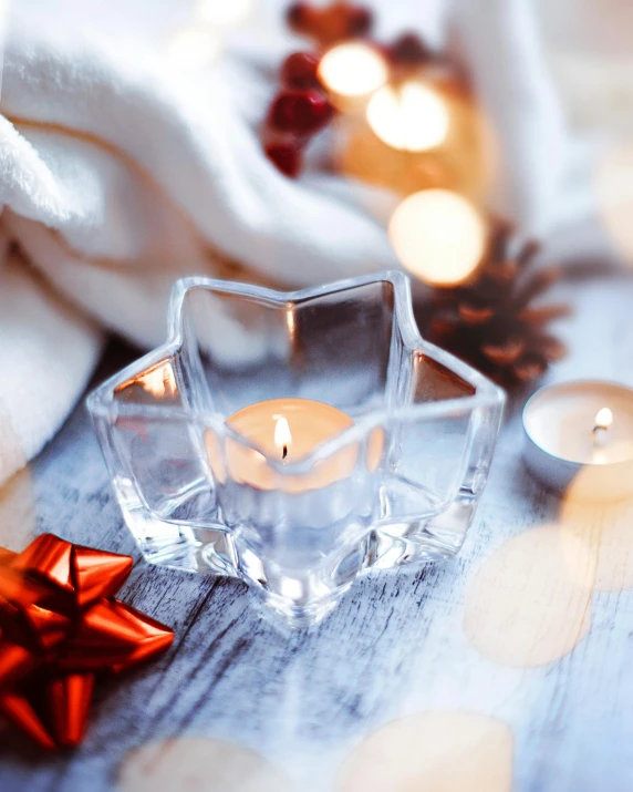 a candle that is sitting on a table, pexels, tactile buttons and lights, large star crystals, product display photograph, lovely bokeh