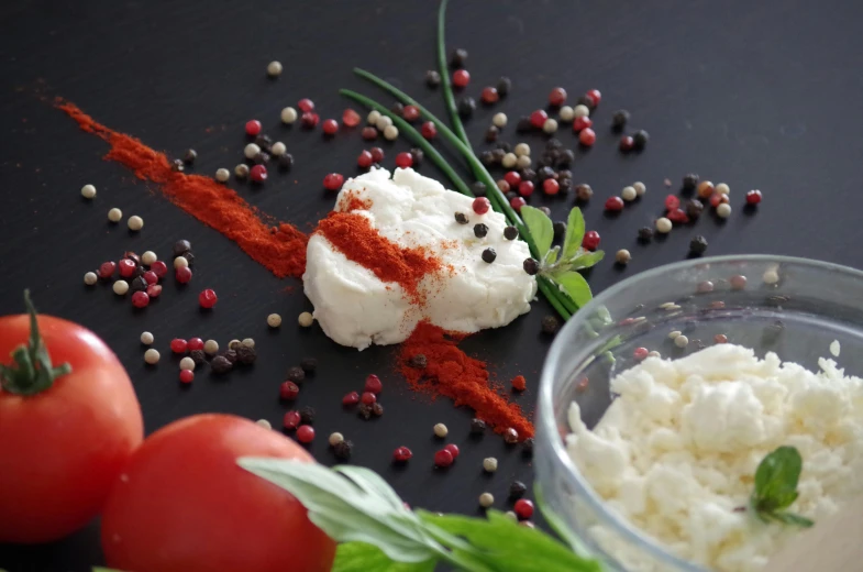 a close up of a plate of food on a table, red and white and black colors, thumbnail, mozzarella, food particles