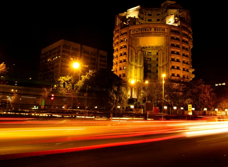 a city street filled with lots of traffic at night, brutalism, talaat harb square cairo, award-winning masterpiece, hotel room, exterior photo