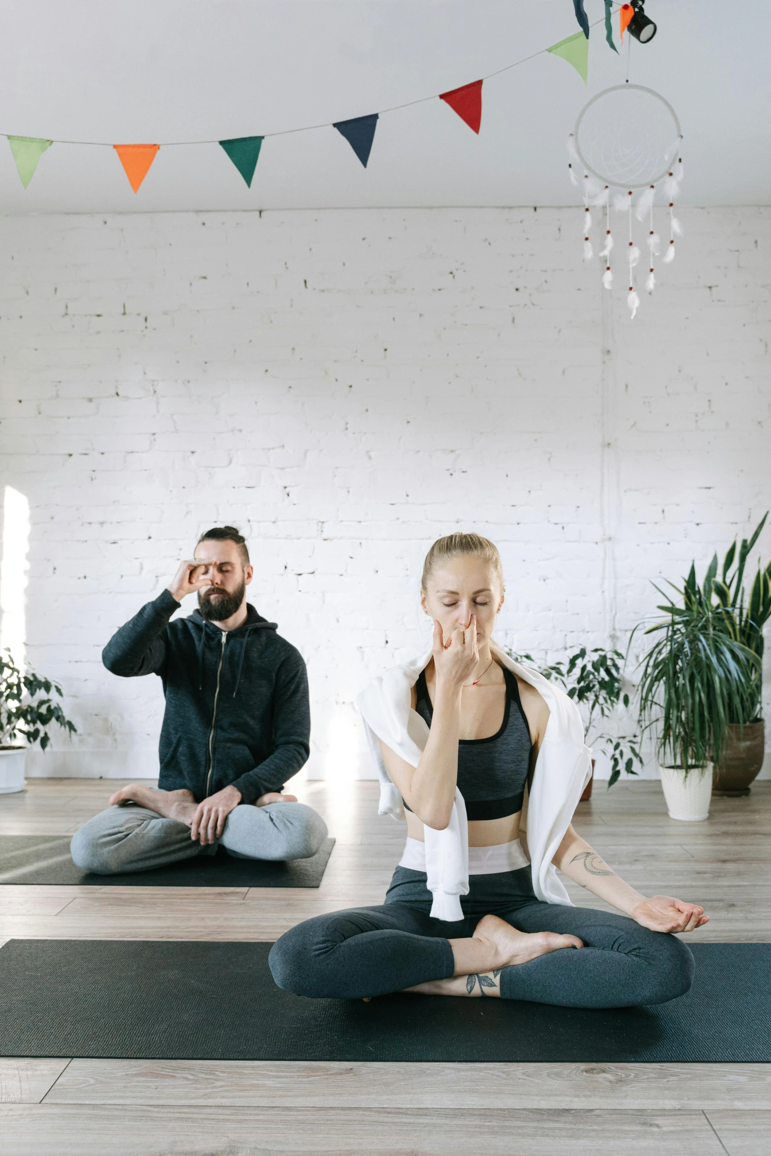 a man and a woman doing yoga together, pexels contest winner, smoking with squat down pose, hear no evil, low quality photo, botanical