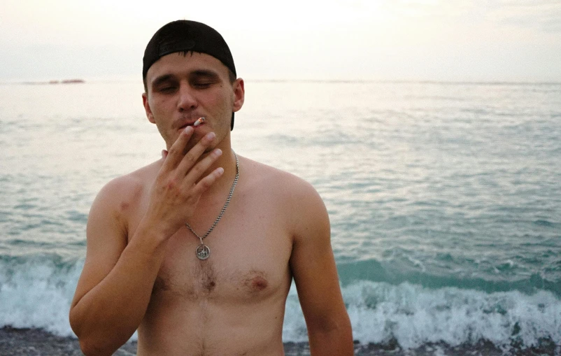 a man standing on a beach smoking a cigarette, pexels contest winner, renaissance, yung lean, hairy chest, kyle hotz, in a sea